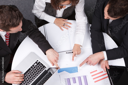 Photo: businessmen discussing an analysis businessmen discussing an analysis