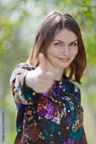Photo: Portrait of attractive young woman on open air Portrait of attractive young woman on open air