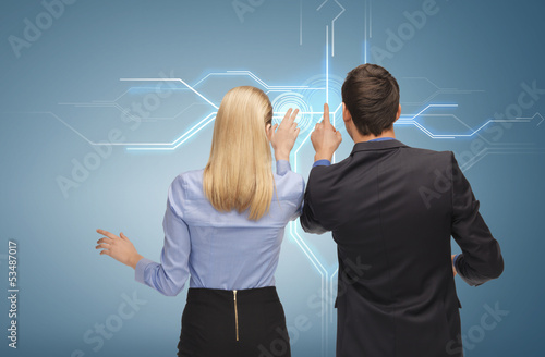 Photo: man and woman working with virtual screen man and woman working with virtual screen