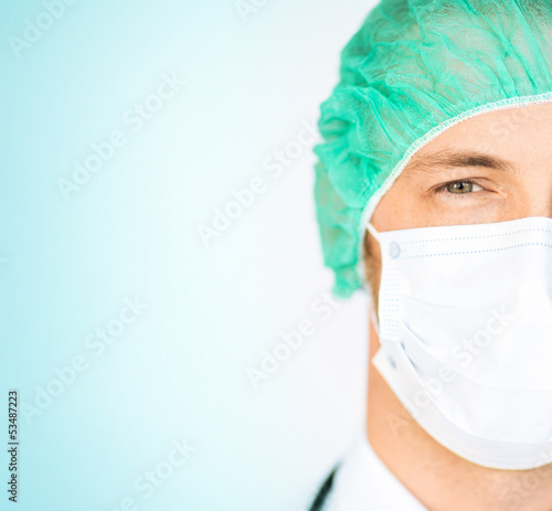 Photo: surgeon in medical cap and mask surgeon in medical cap and mask
