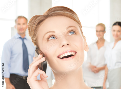 Photo: businesswoman with cell phone calling businesswoman with cell phone calling