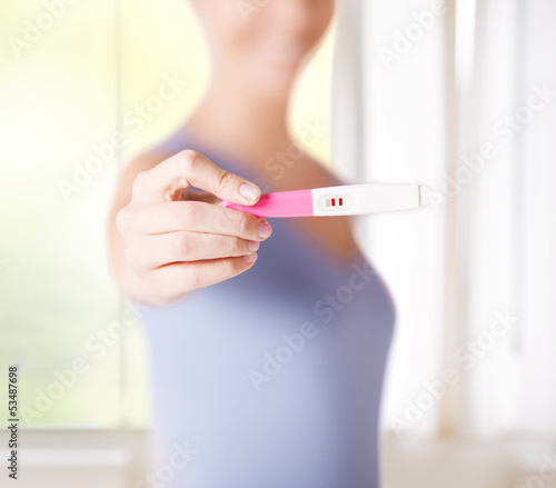 Photo: woman with pregnancy test woman with pregnancy test