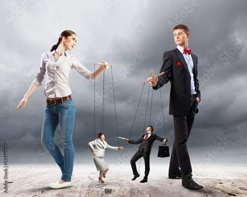 Photo: Businesspeople with marionettes Businesspeople with marionettes