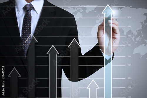 Photo: Business man drawing a graph Business man drawing a graph