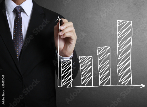 Photo: Business man drawing a graph Business man drawing a graph