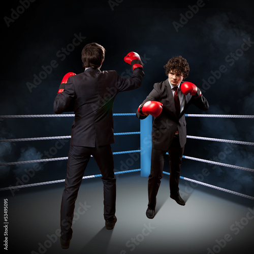 Photo: Two young businessman boxing Two young businessman boxing