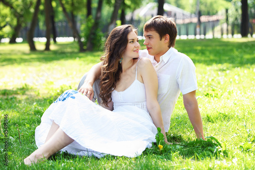 Photo: Young love Couple smiling under blue sky Young love Couple smiling under blue sky