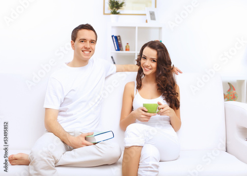 Photo: Young happy couple at hone together s Young happy couple at hone together s