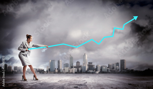Photo: Businesswoman pulling graphic Businesswoman pulling graphic