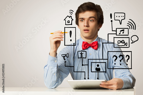 Photo: Young man using laptop Young man using laptop