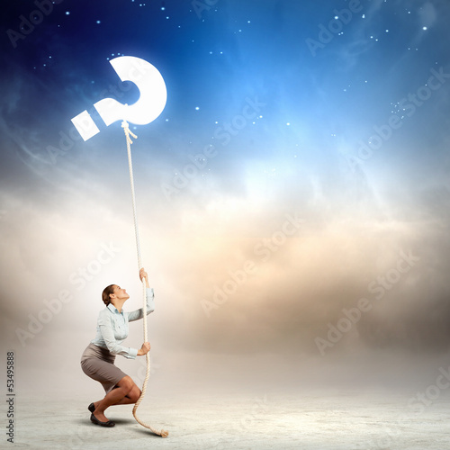 Photo: Woman pulling rope with a question mark Woman pulling rope with a question mark