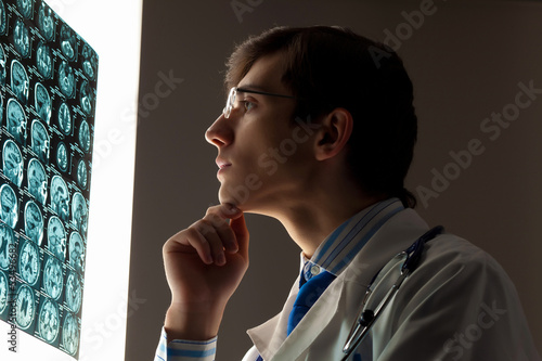 Photo: Man doctor looking at x-ray Man doctor looking at x-ray