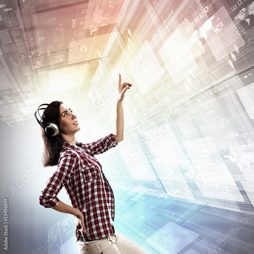 Photo: Woman touching virtual screen Woman touching virtual screen