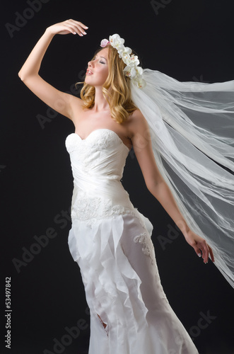 Photo: Woman in wedding dress dancing Woman in wedding dress dancing