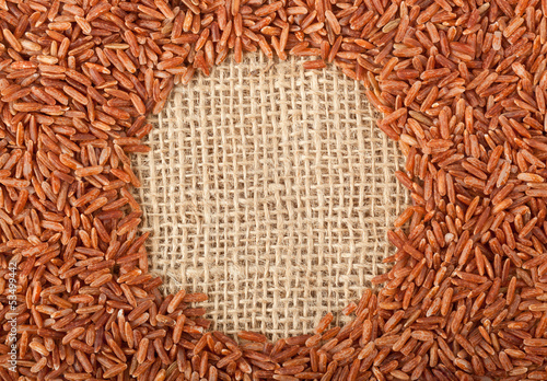 Photo: Brown rice on burlap fabric Brown rice on burlap fabric