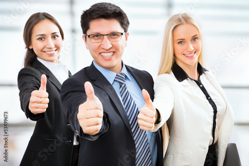 Photo: Business people show thumb up Business people show thumb up