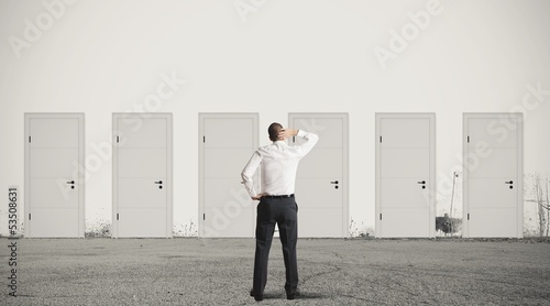 Photo: Businessman choosing the right door Businessman choosing the right door