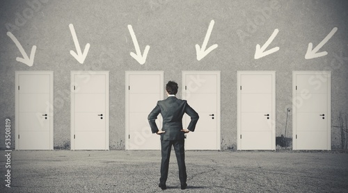 Photo: Businessman choosing the right door Businessman choosing the right door