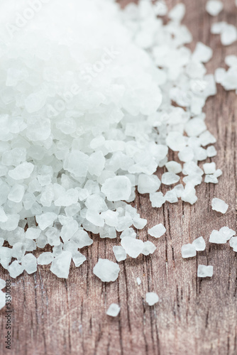Photo: Sea salt over wooden background Sea salt over wooden background