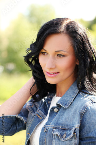 Photo: Beautiful young woman in a park Beautiful young woman in a park