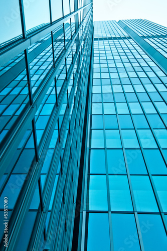 Photo: office buildings. modern glass wall of skyscraper office buildings. modern glass wall of skyscraper