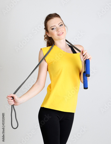 Photo: Beautiful young woman with skipping rope Beautiful young woman with skipping rope