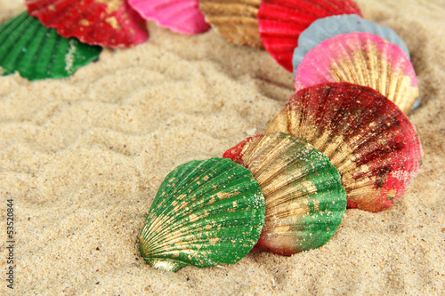 Photo: Colorful seashells on sand background Colorful seashells on sand background