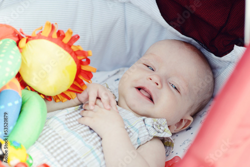 Photo: baby boy laying in pram baby boy laying in pram