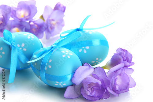 Photo: Bright easter eggs with bows and flowers, isolated on white Bright easter eggs with bows and flowers, isolated on white