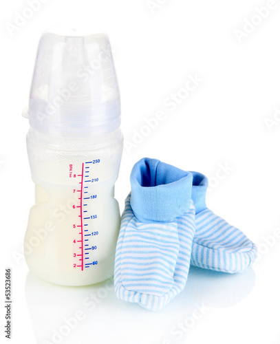Photo: Bottle for milk formula with booties isolated on white Bottle for milk formula with booties isolated on white