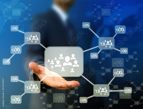 Photo: Businessman holding icon of social network Businessman holding icon of social network