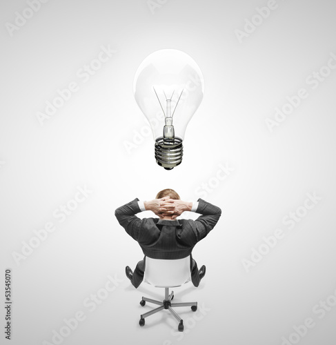 Photo: man drawing lamp over head man drawing lamp over head