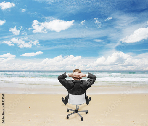 Photo: businnessman sitting on beach businnessman sitting on beach