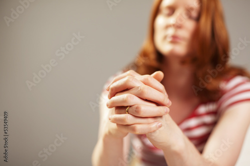 Photo: A female believer praying with faith A female believer praying with faith
