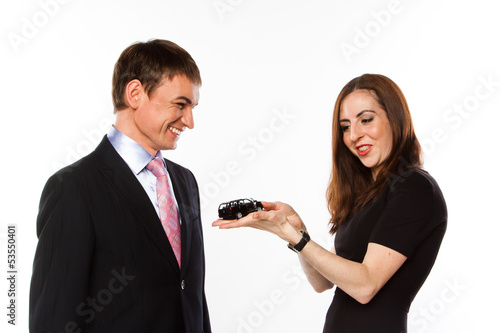 Photo: young man and woman are holding a toy car young man and woman are holding a toy car
