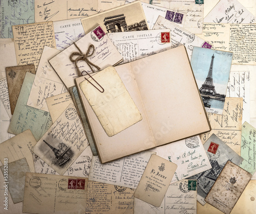 Obraz w ramie old postcards and open book. nostalgic vintage background