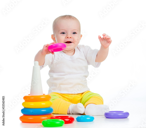 Photo: smiling baby playing with toy isolated on white smiling baby playing with toy isolated on white