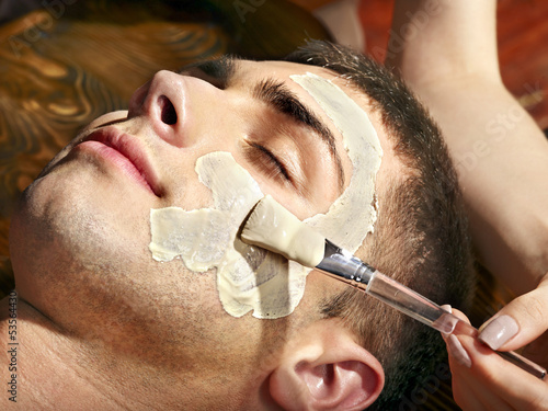 Photo: Clay facial mask in beauty spa. Clay facial mask in beauty spa.
