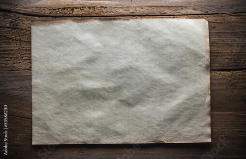 Photo: paper on wooden background paper on wooden background