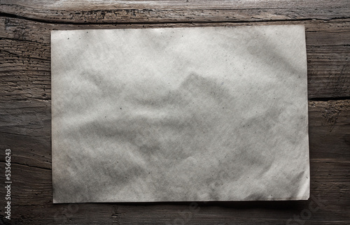 Photo: paper on wooden background paper on wooden background