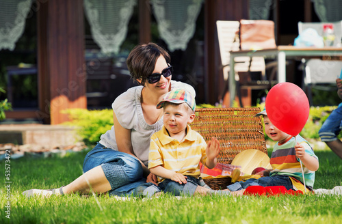 Photo: Photo presenting happy family in the garden Photo presenting happy family in the garden
