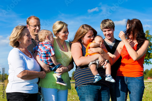 Photo: Family and multi-generation - fun on meadow in summer Family and multi-generation - fun on meadow in summer