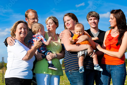 Photo: Family and multi-generation - fun on meadow in summer Family and multi-generation - fun on meadow in summer