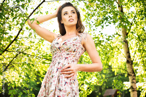 Photo: Young woman enjoying the fresh air in green forest. Young woman enjoying the fresh air in green forest.