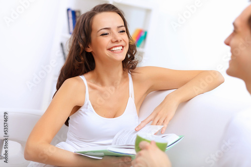 Photo: Young happy couple at hone together s Young happy couple at hone together s