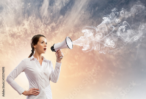 Photo: Businesswoman screaming in megaphone Businesswoman screaming in megaphone