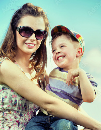 Photo: Attractive mom with her cute little kid Attractive mom with her cute little kid