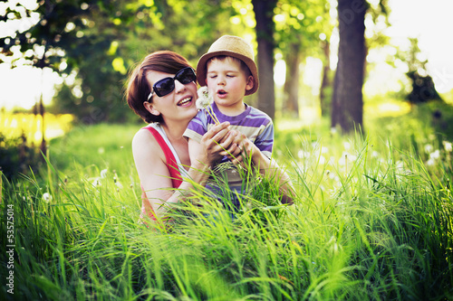 Photo: Colorful photo of mother and kid playing blow-balls Colorful photo of mother and kid playing blow-balls