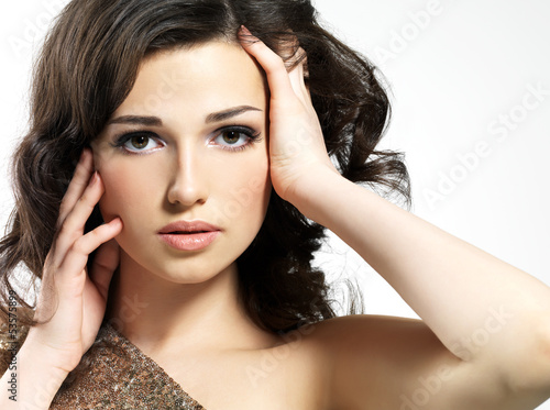 Photo: Beautiful face of woman with curly brown hairs Beautiful face of woman with curly brown hairs