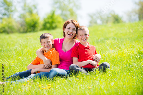 Photo: Young happy mother with children in park Young happy mother with children in park
